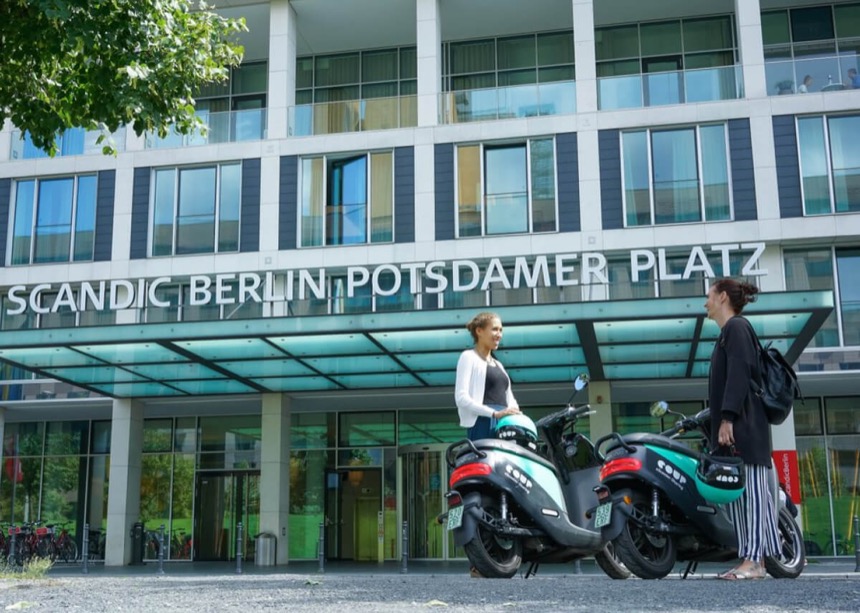 Riders collecting Coup scooters at Potsdamer Platz